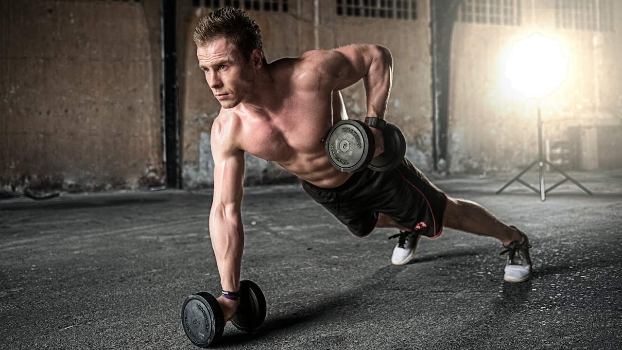 man doing push ups with weights